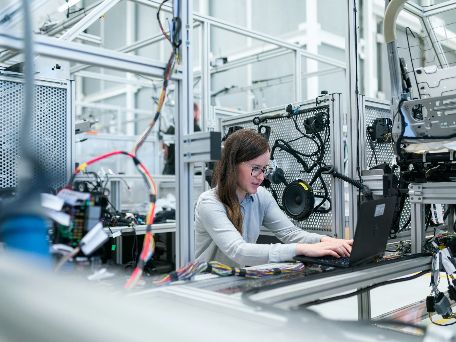 Technician working on a precision assembly line in a manufacturing facility