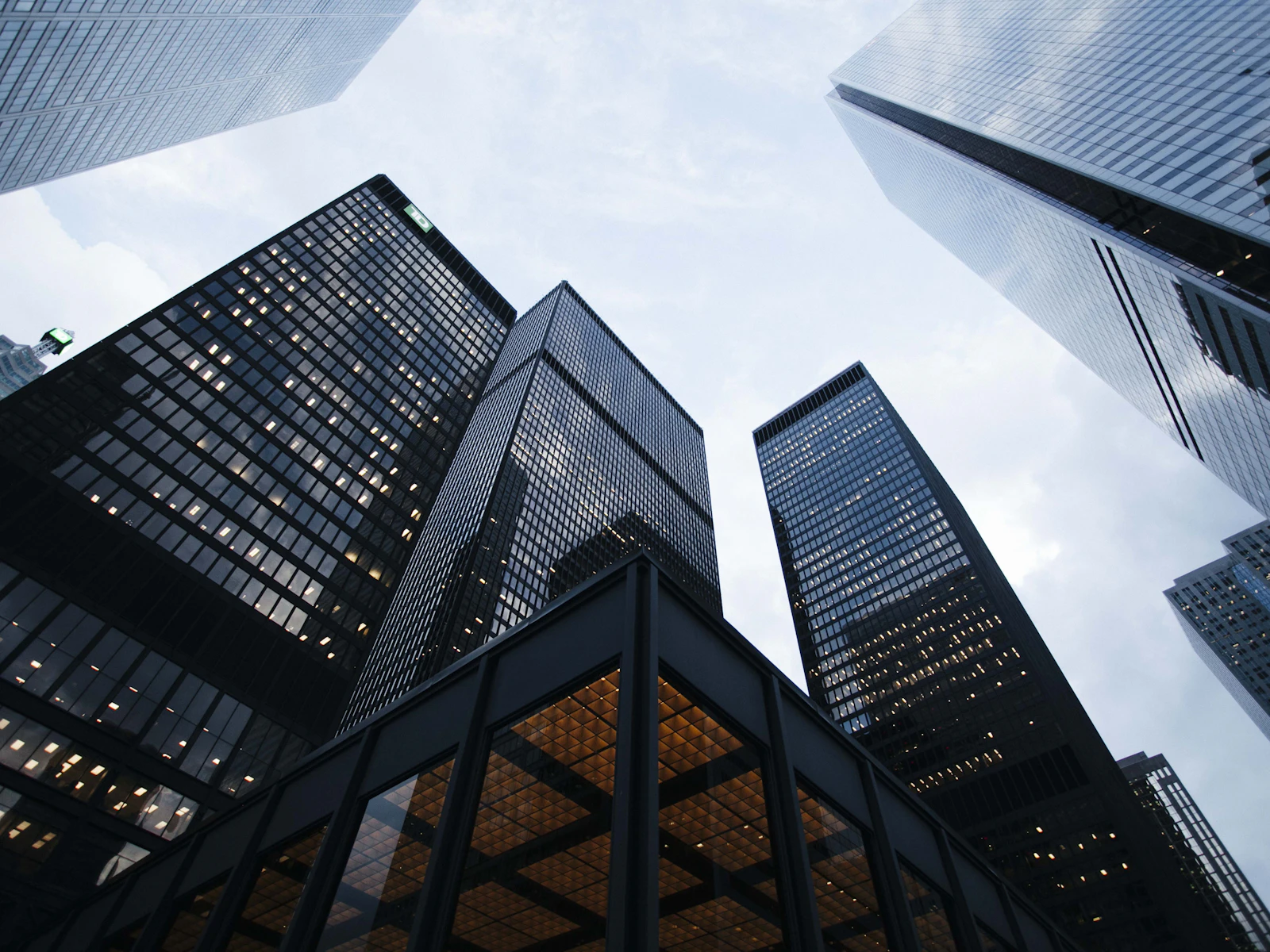 Glass office towers in a downtown financial district, seen from below